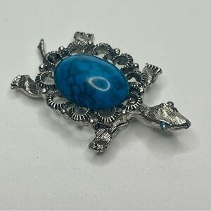 Vintage Gerry's silver-tone turtle brooch with faux turquoise cabochon.